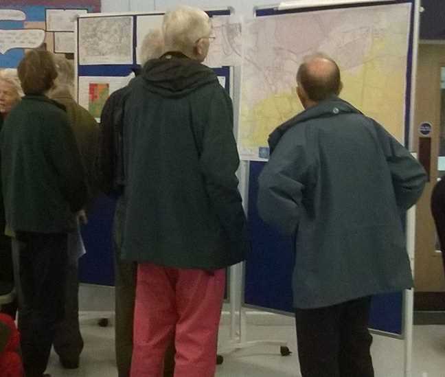 Studying maps at the Survey Review Information Evening in November 2014